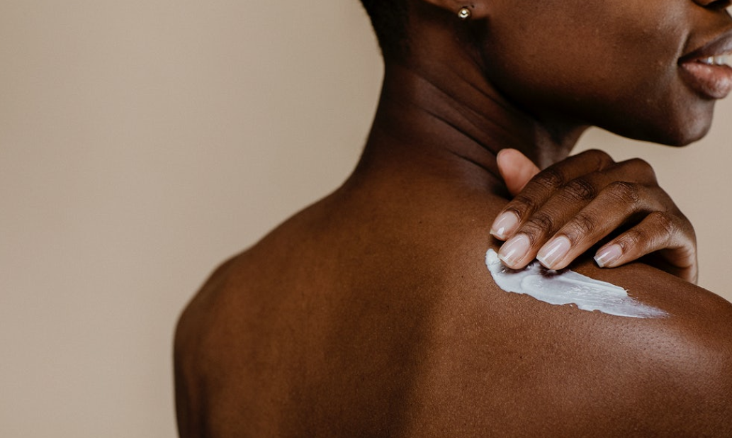 woman applying lotion to her skin